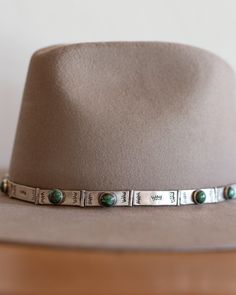 Hand-crafted by Jill Rikkers locally in Ridgway, Colorado just over the mountains from Telluride. Each one of her pieces is handmade and unique, making them the perfect one of a kind accessory. This hat band is made of sterling silver stamped with unique thunderbird design. Accented with green turquoise, this is the perfect statement for any hat. Materials: Sterling Silver and Genuine African Turquoise Stone Adjustable closure in back Ridgway Colorado, Thunderbird Design, Turquoise Hat, African Turquoise, Hat Band, Green Turquoise, Colorado, Turquoise, Band