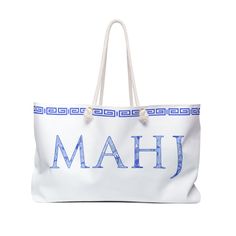 "Our Chinoiserie Mahjong Collection is perfect for all those blue and white lovers! This large tote will carry all your Mahj supplies over to your friends house or to a tournament. The word \"Mahj\" is in a classic blue and white chinoiserie print. It's a great gift as well!  The wide-mouthed, durable bag holds a generous amount of personal items and is easily held by its thick rope handles. .: One size: 24\" x13\" (60.9 cm x 33 cm) .: 100% Spun Polyester .: T-bottom .: Cream sheeting interior lining .: Designed by Mahj Squad and assembled in the USA from globally sourced parts" White Rectangular Beach Bag For Gift, Rectangular White Beach Bag For Gifts, Large White Bags For Vacation, White Shoulder Beach Bag As Gift, Large White Vacation Bag, Large White Vacation Bags, White Large Capacity Beach Bag As Gift, Large Capacity White Beach Bag As Gift, Blue And White Tile