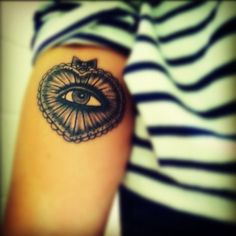 a woman's arm with an all seeing eye tattoo on it