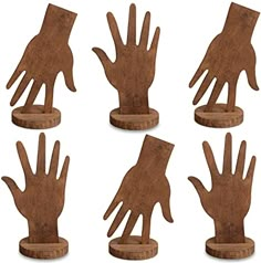 six wooden hand sculptures are shown in this image