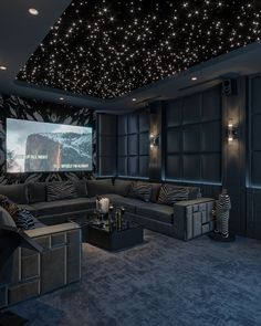 a living room filled with furniture and a projector screen in the middle of it