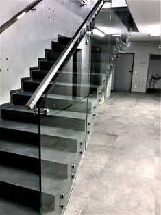 a set of stairs with glass railings