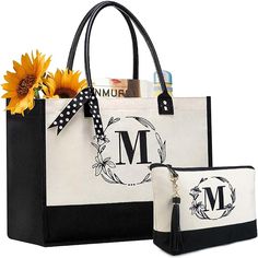 two black and white bags with sunflowers in the front one has a monogram on it