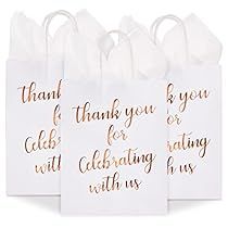 four white bags with gold foil lettering on them