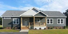 a gray house with white trim and two front porches on the first floor is shown