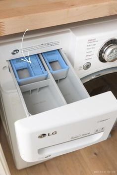 an open dishwasher with two blue containers in it