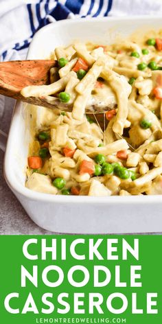 chicken noodle casserole with peas and carrots in a white baking dish