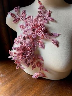 a white mannequin with pink flowers on it