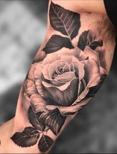 a black and white rose tattoo on the arm