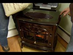 two people are standing next to an oven