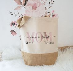 a bag with the word mom printed on it sitting on a white furnishing