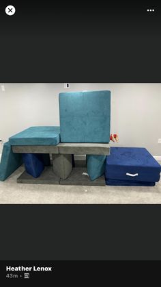 a blue couch and ottoman sitting on top of each other