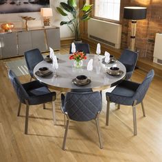 a dining room table with blue chairs around it