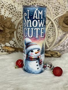 i am snow cute tumbler cup with christmas decorations on the table next to it