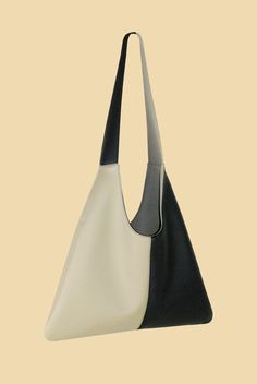 Introducing our best-selling Agave Triangular Tote, but much larger. We love a triangular shape that can elevate even some dressed-down casual jeans. Perfect go-to bag that never compromises style (or the environment!). Made from pebbled black and beige cactus leather, the Agave Triangular Tote XL features a magnetic closure, a blind embossed logo and an interior slip pocket. Product Info: Height: 63cmStrap Drop: 40cmWidth: 46cm Handmade in New York City. In collaboration with Desserto, our plan Black And Beige, Embossed Logo, Casual Jeans, Magnetic Closure, Love A, Laptop Bag, Tote Handbags, Leather Handbags, Plant Based