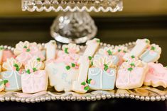 decorated cookies are sitting on a silver platter