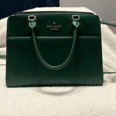 Emerald Green Kate Spade Handbag With Golden Hardware Never Used. Brand New. Smoke Free Home High-end Green Satchel For Shopping, High-end Green Satchel With Double Handle, Classic Green Bag With Detachable Handle, Classic Green Handheld Bag, Classic Green Handheld Satchel, Elegant Green Bag With Top Carry Handle, Green Handheld Satchel With Gold-tone Hardware, Classic Green Bag With Top Carry Handle, Elegant Green Satchel With Top Carry Handle