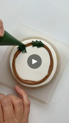 someone is decorating a cake with green icing