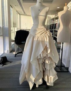 a mannequin is dressed up in a white dress with ruffles on it