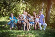 a group of children sitting on a bench in the grass with their faces close together