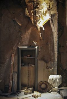 an old room with a broken mirror and books