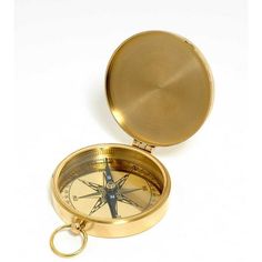 an open brass compass on a white background