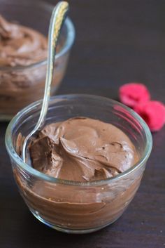 two bowls filled with chocolate pudding on top of a table