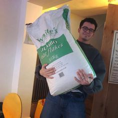 a man holding a large bag of rice in his hands