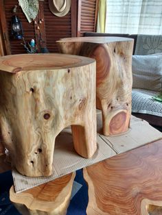 three pieces of wood sitting on top of each other in the middle of a room