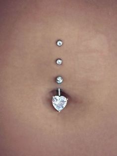 a woman's stomach with three diamonds on it and a heart shaped diamond in the middle