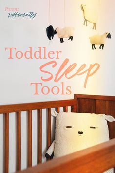 a baby crib with stuffed animals hanging from it's sides and the words toddler sleep tools above it