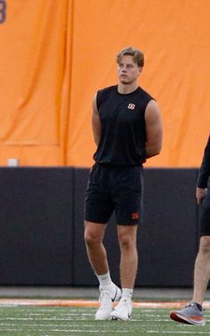 two men standing next to each other on a field