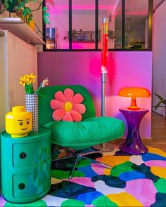 a brightly colored room with a green chair and flower pot on the table next to it