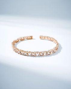 Crafted with 18-karat gold, this bangle is set with shimmering baguette and round white diamonds in Suzanne's 'Frenzy' design. It is also made with a 18-karat spring gold wire making it flexible and easy to slip on and off. Details 18k yellow gold, rose gold or white gold 1.63 carats of baguette and round white diamonds Model is styling bangle in yellow gold, second from the top 5.75mm width Ref: AKB575D 18k Gold Bangle, Rainbow Sapphires, Tennis Necklace, Diamond Bangle, Gold Wire, White Rose Gold, White Diamonds, Gold Bangles, Diamond Wedding Bands