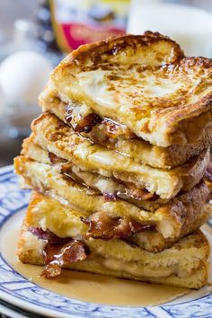 a stack of french toast sitting on top of a blue and white plate