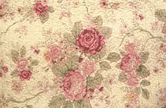 an old quilt with pink flowers on it