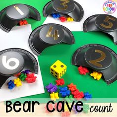 paper plates with numbers and dices on them to make a bear cave counting game