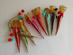 five different colored hair clips with tassels and pom - poms on them