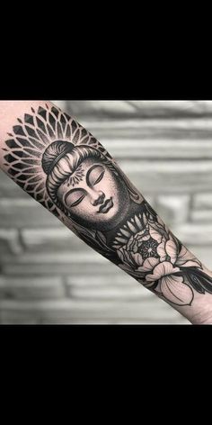 a person with a buddha tattoo on their arm