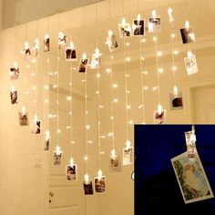 a room with pictures hanging from the ceiling and lights on the wall above it,