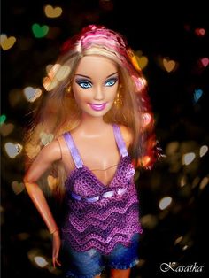 a barbie doll is standing in front of some lights