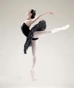 a ballerina in black and white poses for the camera