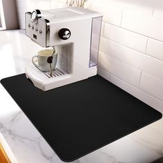 an espresso machine with a cup on the counter