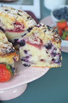 blueberry muffins on a pink plate with strawberries