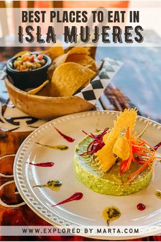 a plate with guacamole and chips on it next to a bowl of salsa