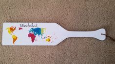 a bottle opener with the word world map painted on it