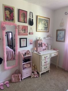 a bedroom with pink furniture and pictures on the wall