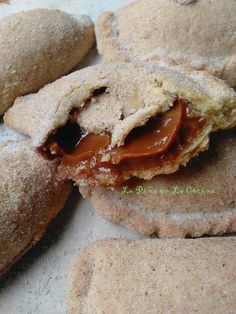 several pastries with peanut butter and jelly on them are sitting on a white surface