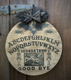 a wooden plaque with an image of a bat hanging from it's side