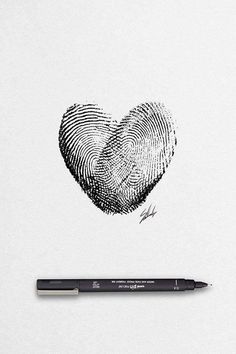 a pen is next to a drawing of a fingerprint heart